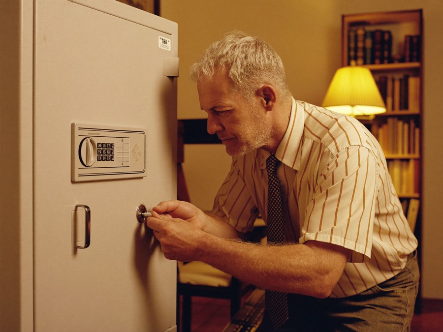 Locksmith opening a home safe by its combination dial