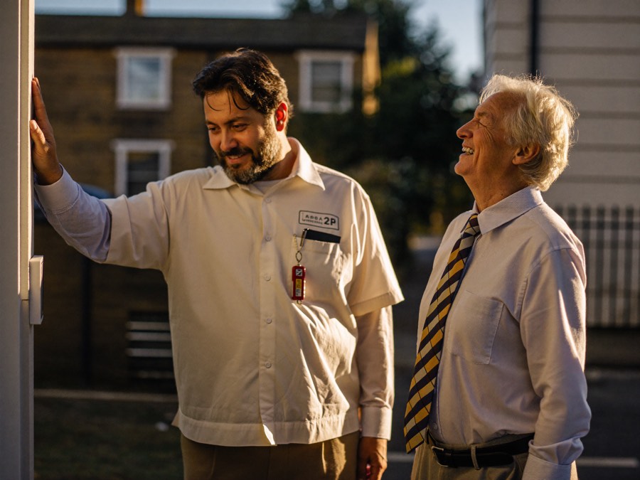 Locksmith reviewing a home security checklist with a homeowner at their door
