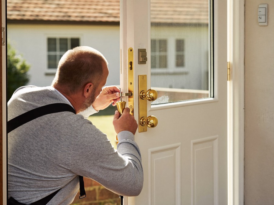 Locksmith adjusting the multipoint locking mechanism on a uPVC door